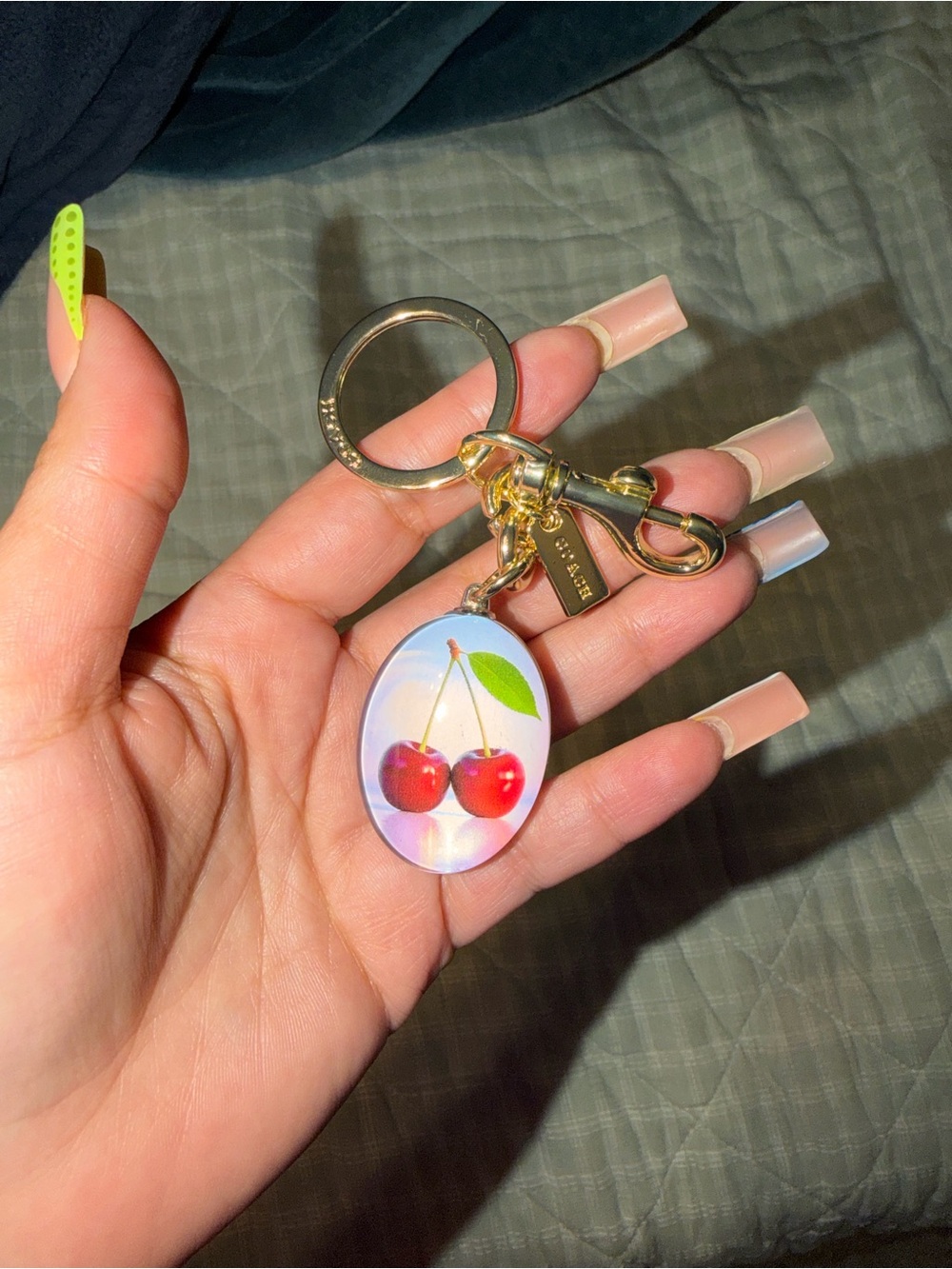 Coach Gold-Tone Cherry Keychain with Iridescent Oval Charm